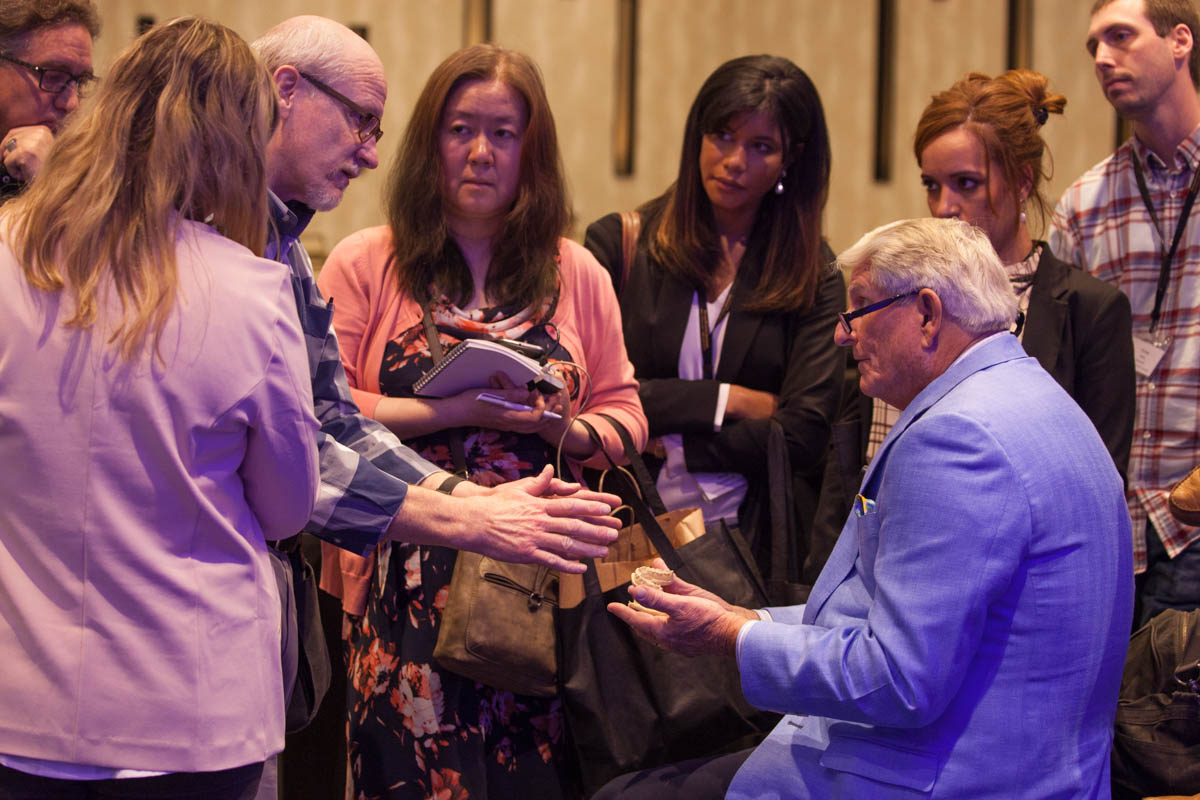 Attendees gathered around Dr. Strupp for a hands-on demonstration between sessions